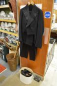 Top hat and tails and a pair of shoes.