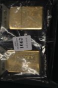 Two Zippo lighters engraved with the initials AFC.