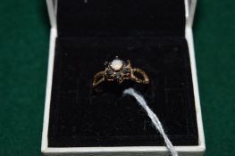 A 9ct gold sapphire and opal ring.