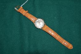 A gentlemans wristwatch with leather strap, the case stamped 14k.