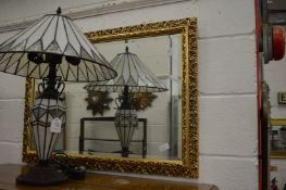 A decorative gilt framed mirror.