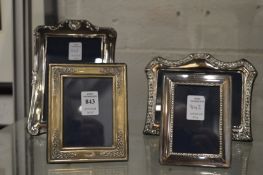 Four silver photograph frames.