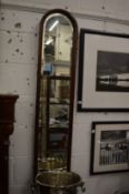 A narrow mahogany framed arch topped mirror.