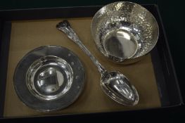 Three items of silver comprising a hammered bowl, circular dish and table spoon.