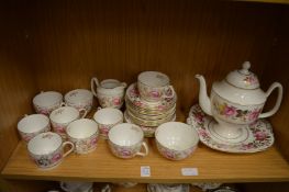 Coalport part tea and coffee service, gilt decorated with pink roses.