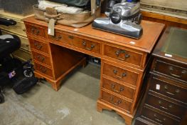 A reproduction yew wood pedestal desk.