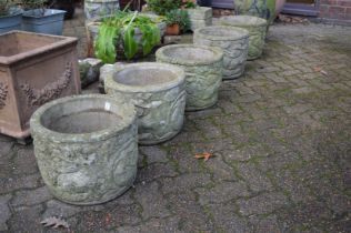 A set of five reconstituted stone circular planters.