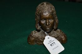 A small cast bronze bust of a woman.