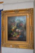 Still life of flowers and fruit on a ledge, oil on board in a decorative gilt frame.