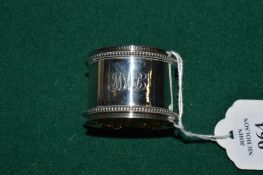 A plain silver napkin ring.