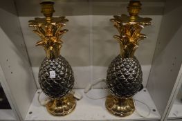 A pair of pineapple shaped pottery table lamps.