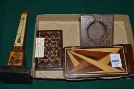 Tunbridge ware, a spire shaped thermometer, a watch holder, paperweight and note book cover.