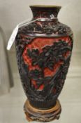 A Chinese cinnabar lacquer vase on stand.