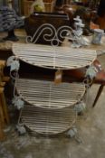 A painted wrought iron three-tier stand.