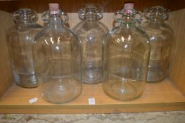 Five demijohns.