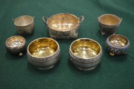 A small Russian silver and enamel circular salt and other silver salts.