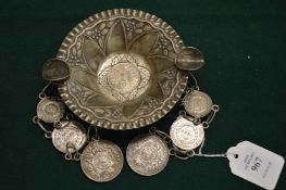 An Eastern white metal tray with coin mounted decoration.