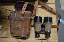 A leather cased pair of binoculars.