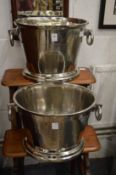 A pair of polished cast metal twin handled Champagne buckets.
