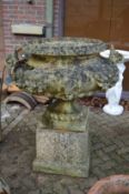 A good large Classical style reconstituted stone urn on pedestal base.