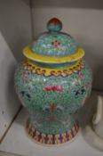 A Chinese famille jaune baluster shaped vase with associated cover.