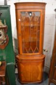 Reproduction yew wood standing corner cabinet.