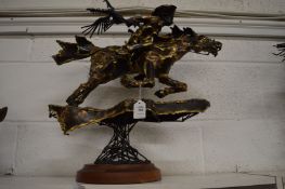An unusual metal sculpture of a cowboy on horseback.