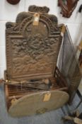 Cast iron fireback, a fire grate, spark guards and tools.