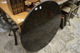 A slate circular table with chrome base together with a glass and metal coffee table.