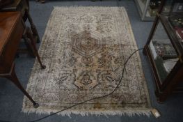 A Persian style rug, beige ground with stylised decoration, 175cm x 127cm.