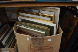 A box of paintings and prints.