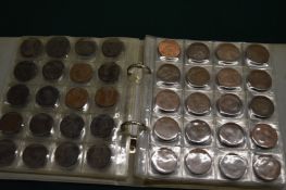 A folder containing a collection of pre-decimal pennies.