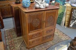 A Chinese redwood two door TV cabinet.