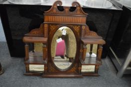 An Edwardian inlaid mahogany small over-mantel mirror with shelves.