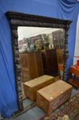 A large carved oak framed over-mantel mirror in Jacobean style.
