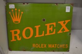 A reproduction Rolex enamel sign.