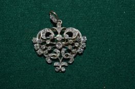 A gold and diamond set combination brooch and pendant.