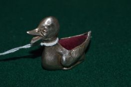 A silver duck shaped pin cushion.