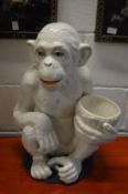 An Italian white glazed pottery model of a seated monkey.