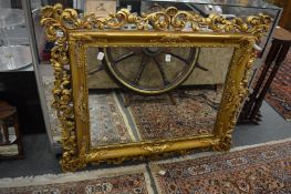 An ornate gilt framed mirror.