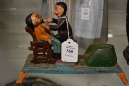 Cast iron money bank (?) depicting a dentist and patient.