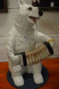 A large Italian pottery model of a bear playing the squeeze box.
