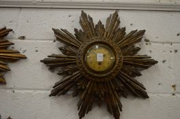A sunburst wall clock.