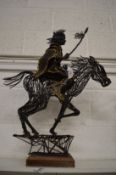 An unusual metal work sculpture of an Indian brave on horseback.