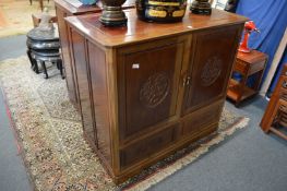 A Chinese redwood two door TV cabinet.