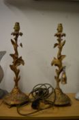 A pair of ornate gilt metal table lamps.