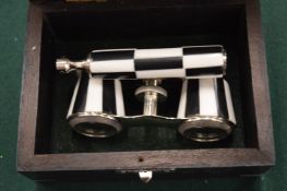 A cased pair of opera glasses.