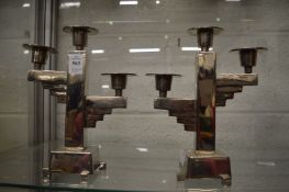 A pair of stylish chrome plated three light candlesticks.