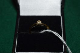 A 9ct gold and diamond solitaire ring.