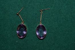 A pair of 9ct gold and amethyst oval shaped earrings.